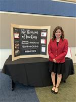 Patricia Gamez poses at State with her presentation board. 